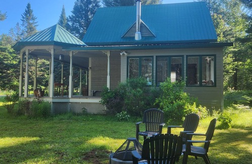 Mandeville Ski Chalet | A small, rustic cabin surrounded by trees, with access to an alpaca farm!