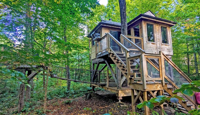Perched treehouse built around a tree, bridge and deck | Lodging #12 in Mont-Blanc